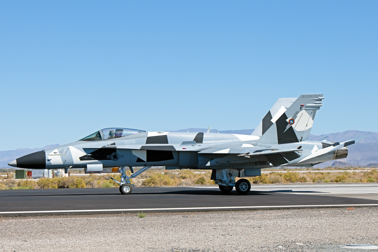 a FA-18C recently transferred to NAWDAC from VFC-12/Fighting Omars. This aircraft carries an Arctic camouflage that VFC-12 has on a few of their jets, but is the first at Fallon.